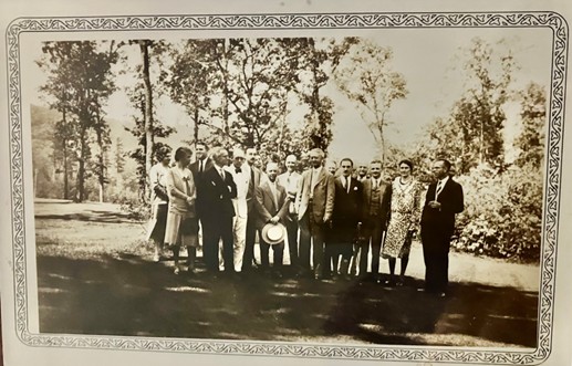 Group photograph of the scientists and supporters who gathered at Highlands in June 1930, set in a decorative border