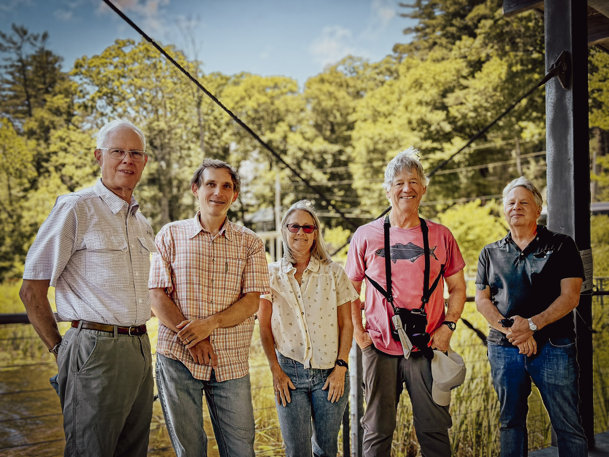 Five people stand together: Brock Hutchins, Jason Love, Melanie Vickers, Rob Bierregaard, and Brent Martin