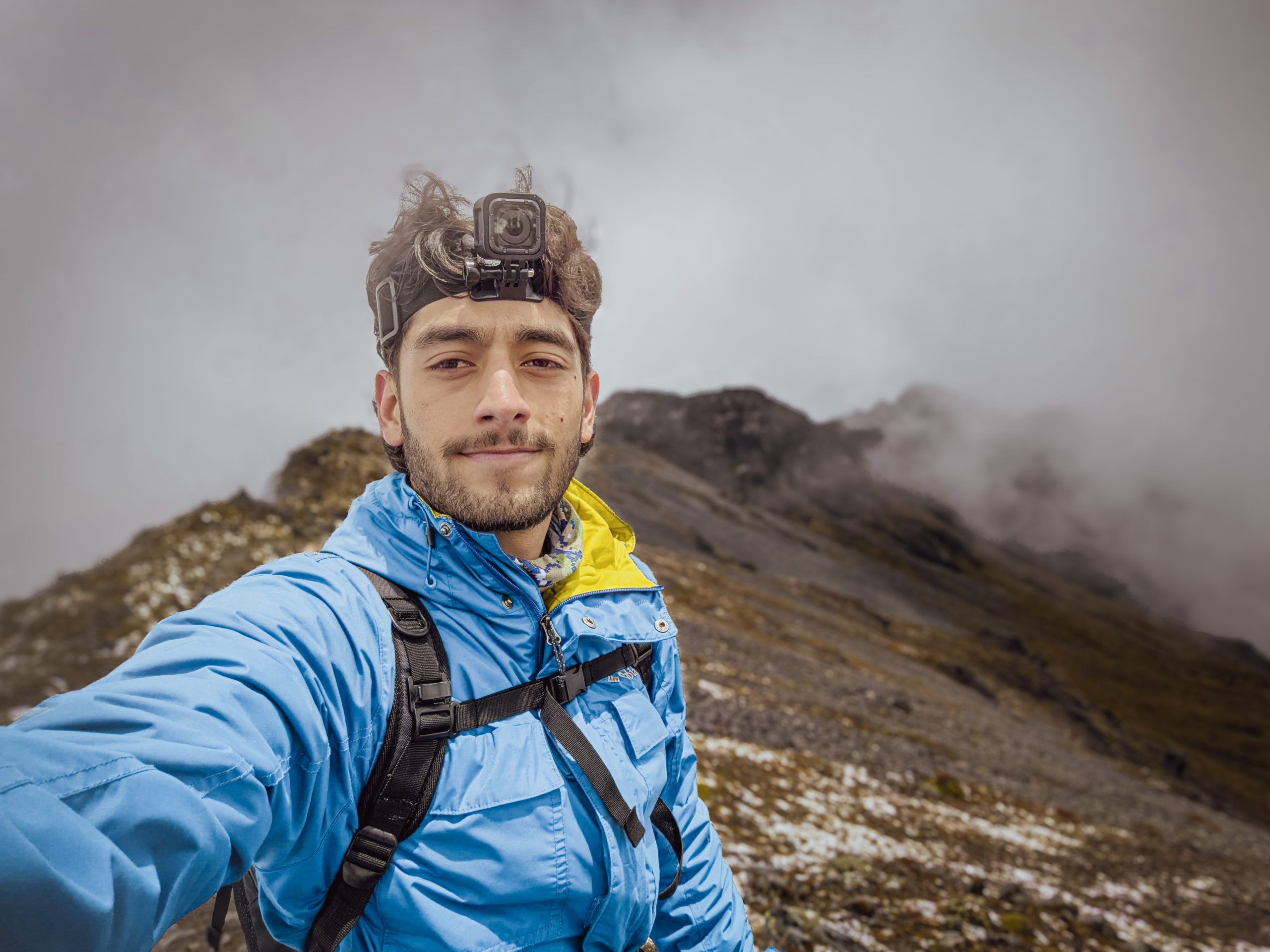Juan Pablo Castro stands on a fog-wrapped ridgeline in the Ecuadorian highlands.