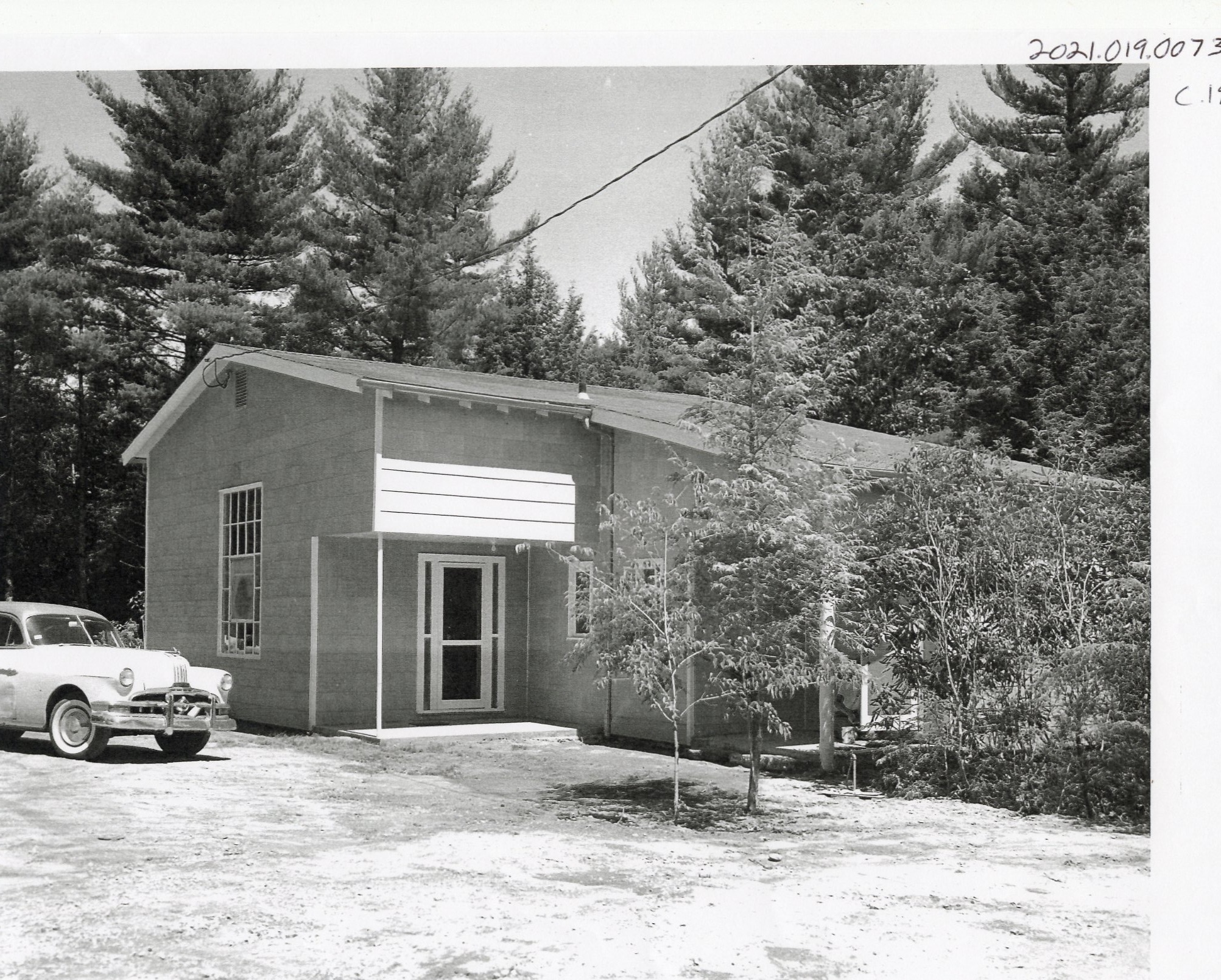 The front of the Weyman building around 1961, after the conversion: shingled walls and a gabled roof in place of the original flat roof.